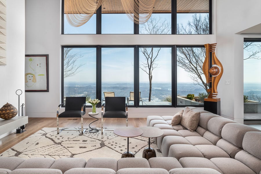 Modern, sleek living room with large sliding doors overlooking amazing views