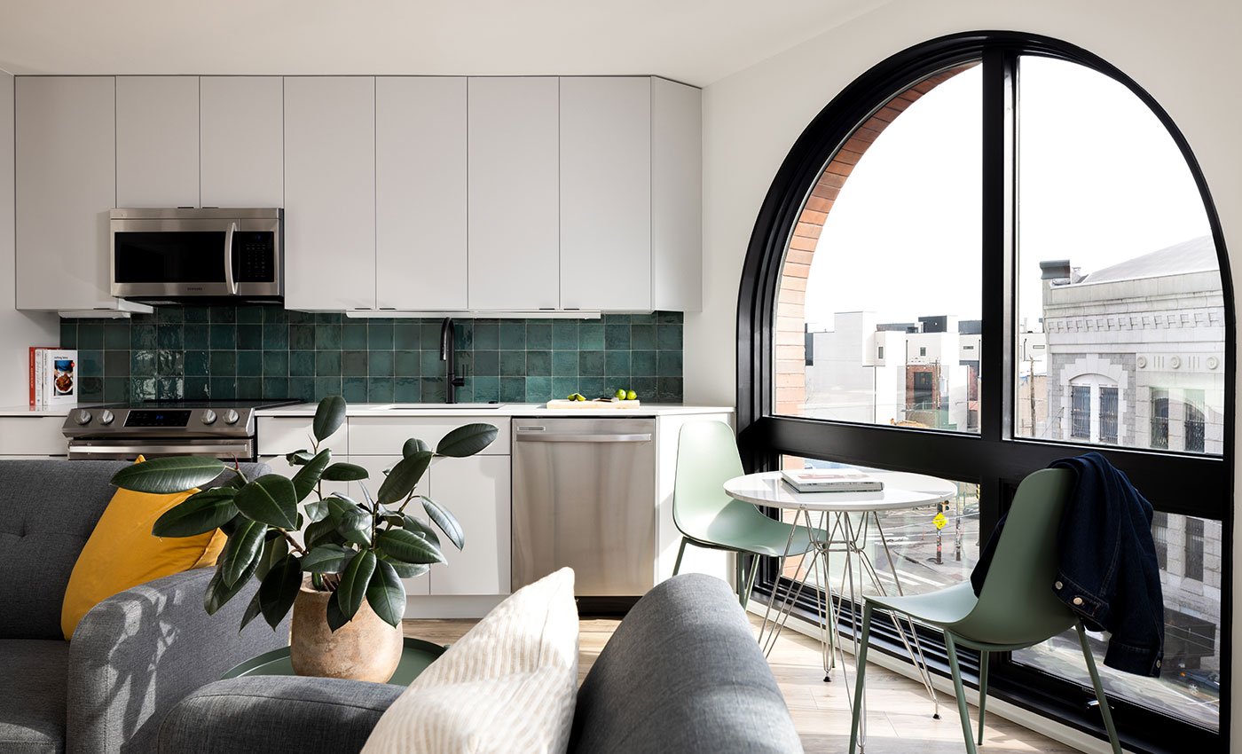 An apartment with a large arched window combination unit made of Andersen® E-Series Specialty Windows.