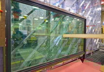 testing being done on window with board penetrating glass