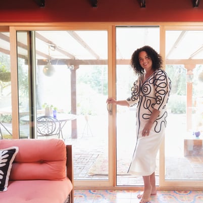 Justina Blakeney opening wood frame sliding door